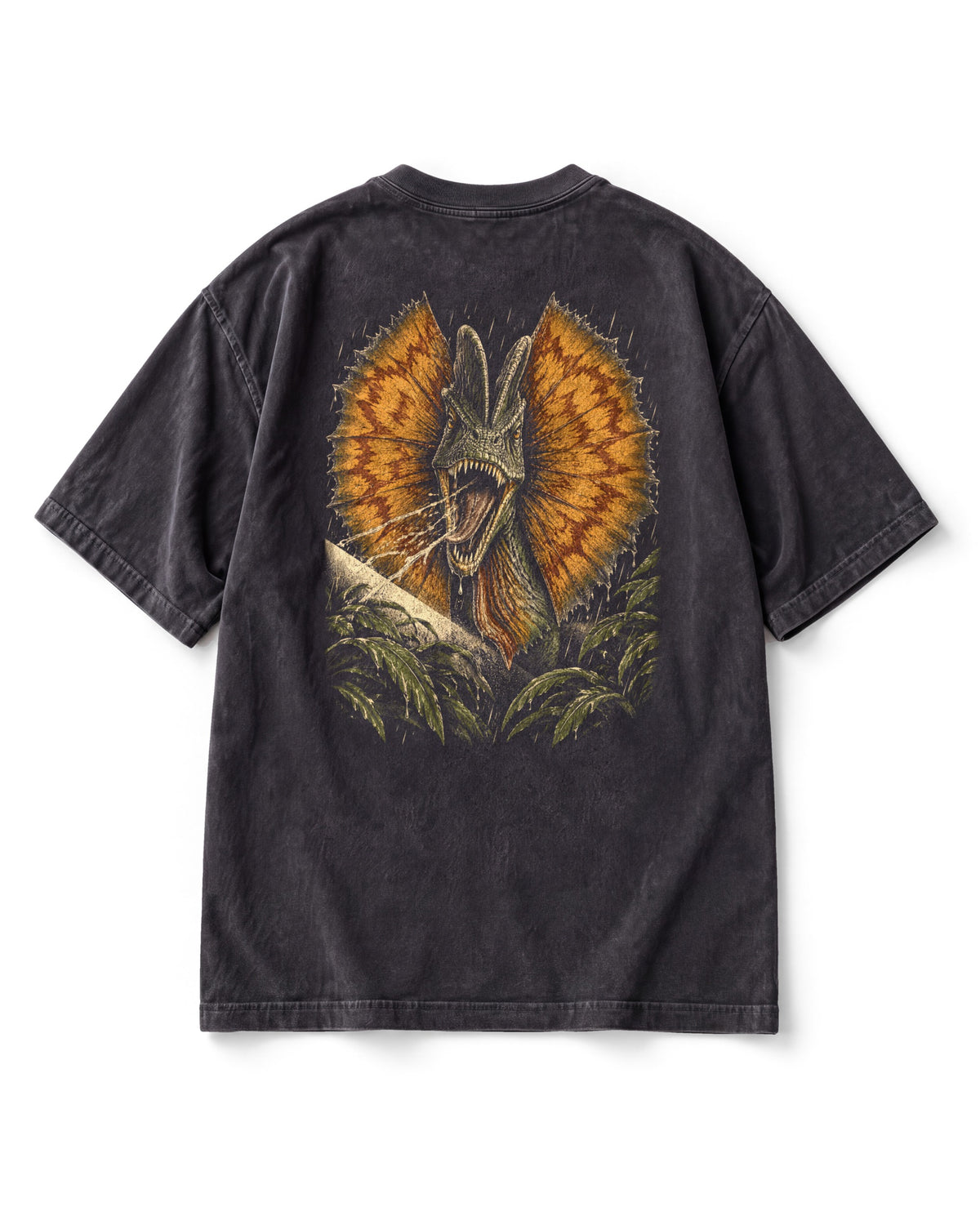 Back print: a Dilophosaurus with a huge orange frill flared and mouth open, rain and jungle leaves around it.