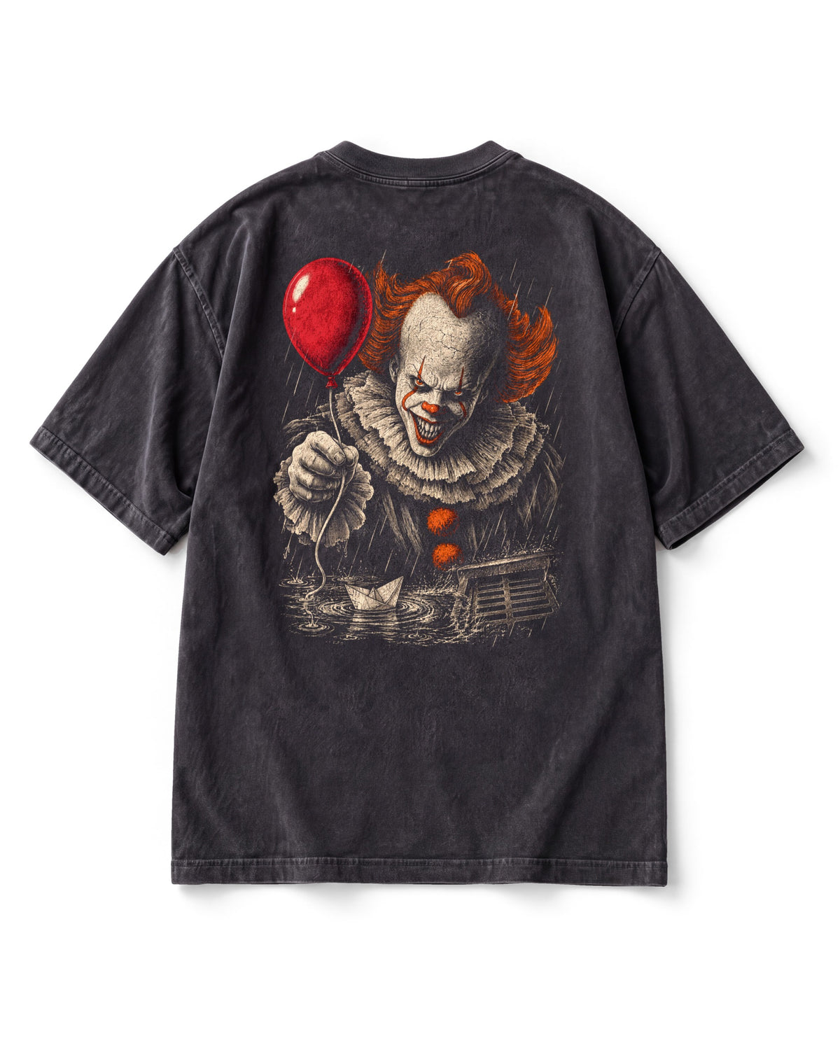 Back print: a grinning clown with orange hair holding out a red balloon, a paper boat floating toward a storm drain below.