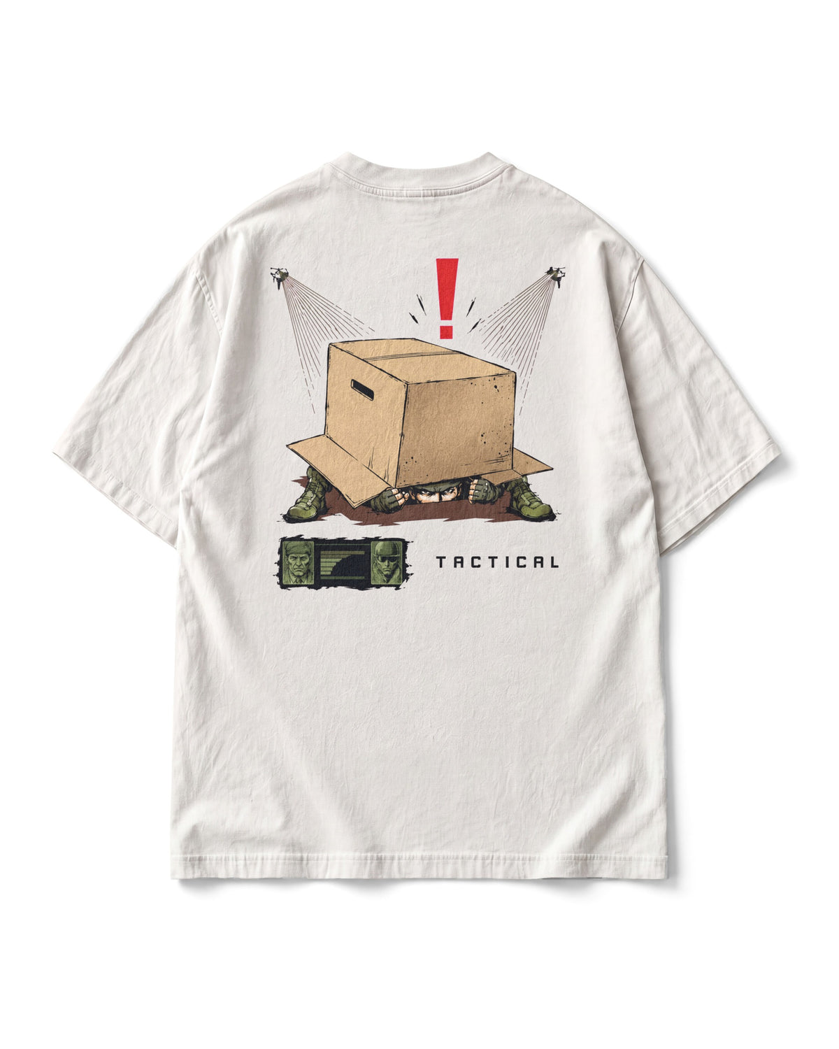 Back print: Solid Snake hiding under a cardboard box, eyes showing, a red alert mark above, searchlights, TACTICAL below.
